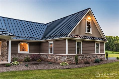 tan house with black metal roof|ranch homes with black roof.